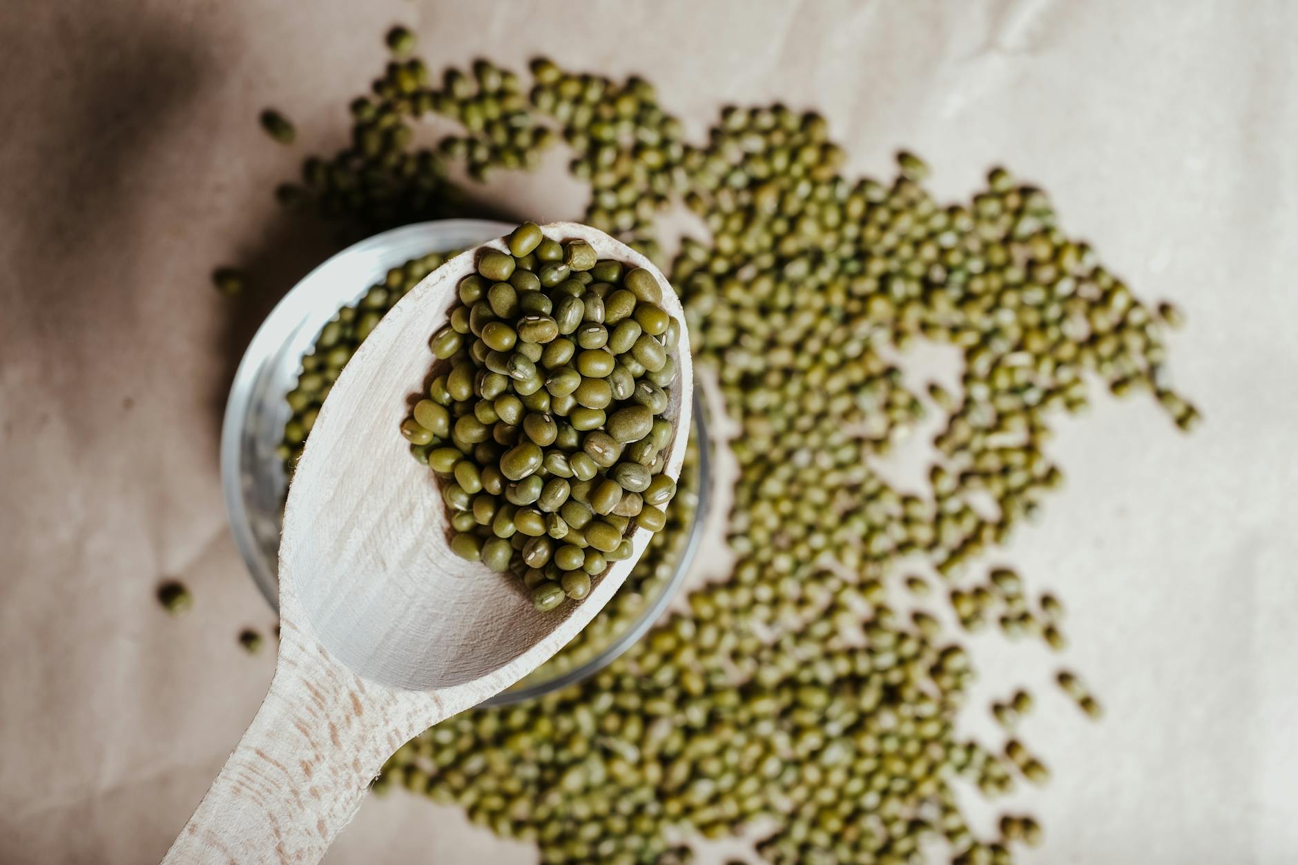 mung beans on wooden spoon